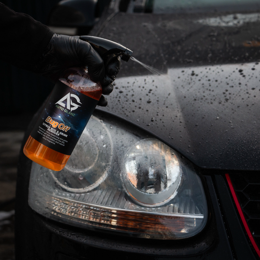 Spraying Auto Glanz Bug Off on a car bumper to dissolve stubborn insect remains.