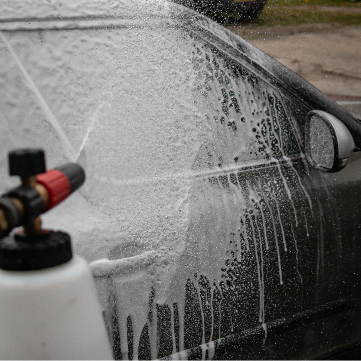 Applying Auto Glanz Cannon Coat via foam lance for instant ceramic protection.